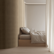 Slaapkamer met gebogen wand bekleed met flexibel akoestisch paneel in natuurlijk eiken